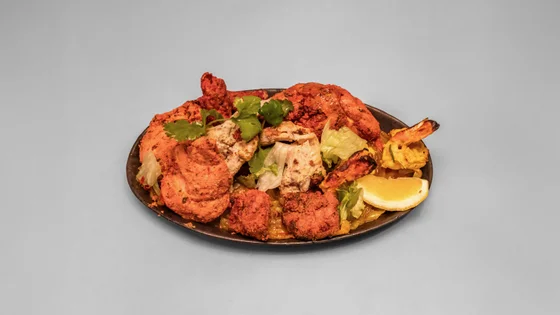 Tandoori mix grill platter from Spicy Tadka, tandoori chicken and kebabs with salad and a lemon wedge